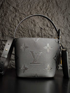 Louis Vuitton monogram bucket bag in gray with side strap and gold hardware