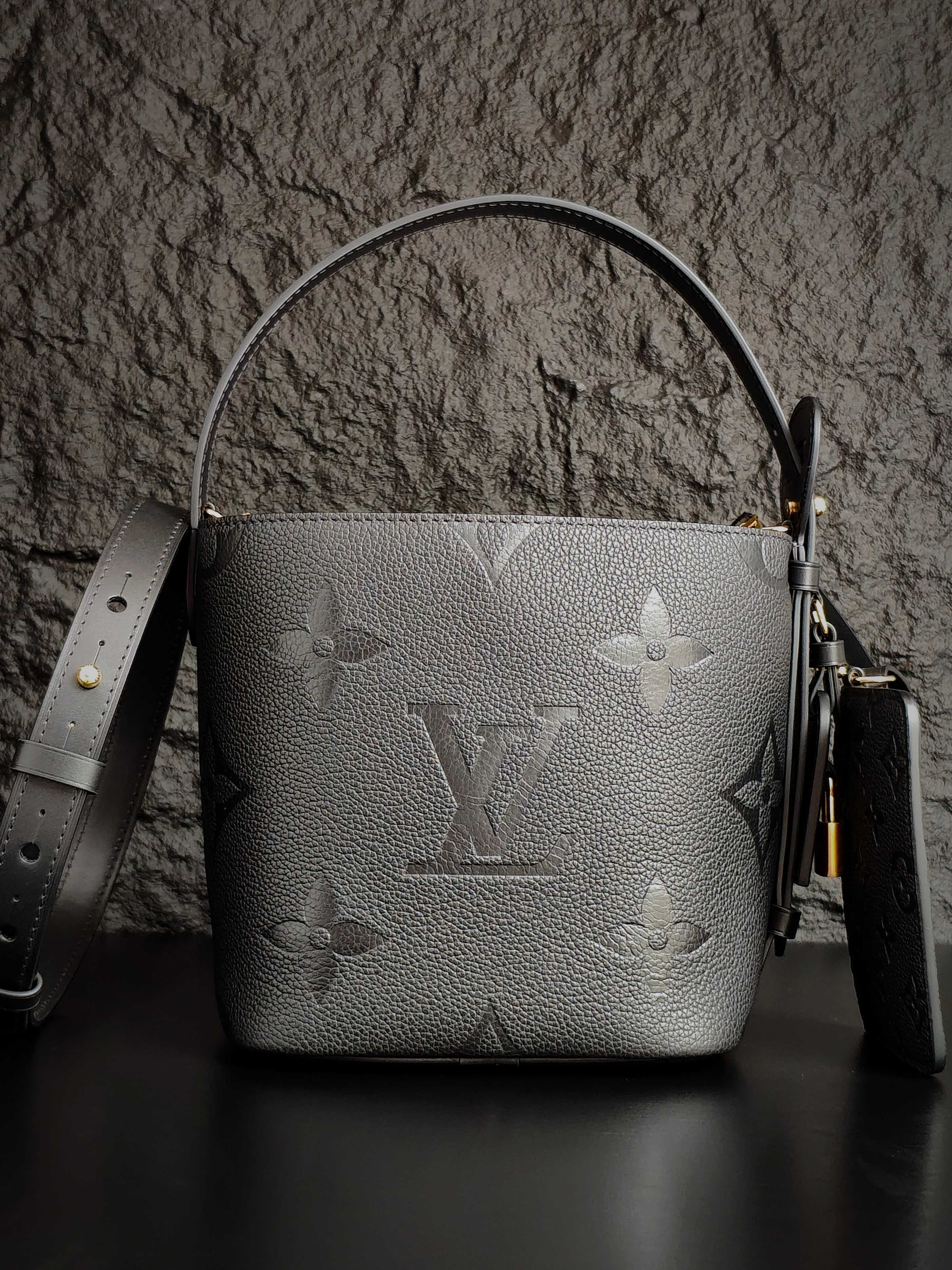 Louis Vuitton monogram bucket bag in gray with side strap and gold hardware