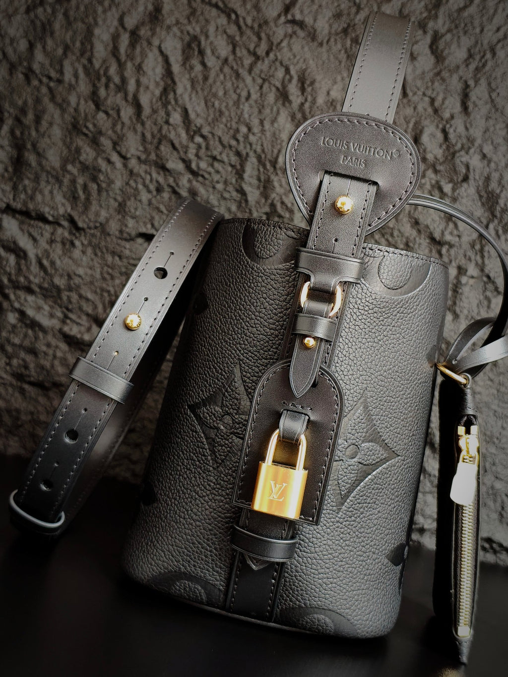 Louis Vuitton monogram bucket bag in gray with front lock charm and shoulder straps