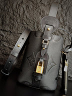 Louis Vuitton monogram bucket bag in gray with front lock charm and shoulder straps