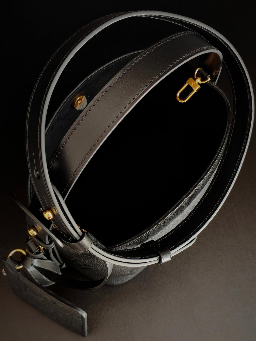 Louis Vuitton monogram bucket bag strap with gold buckle hardware in gray