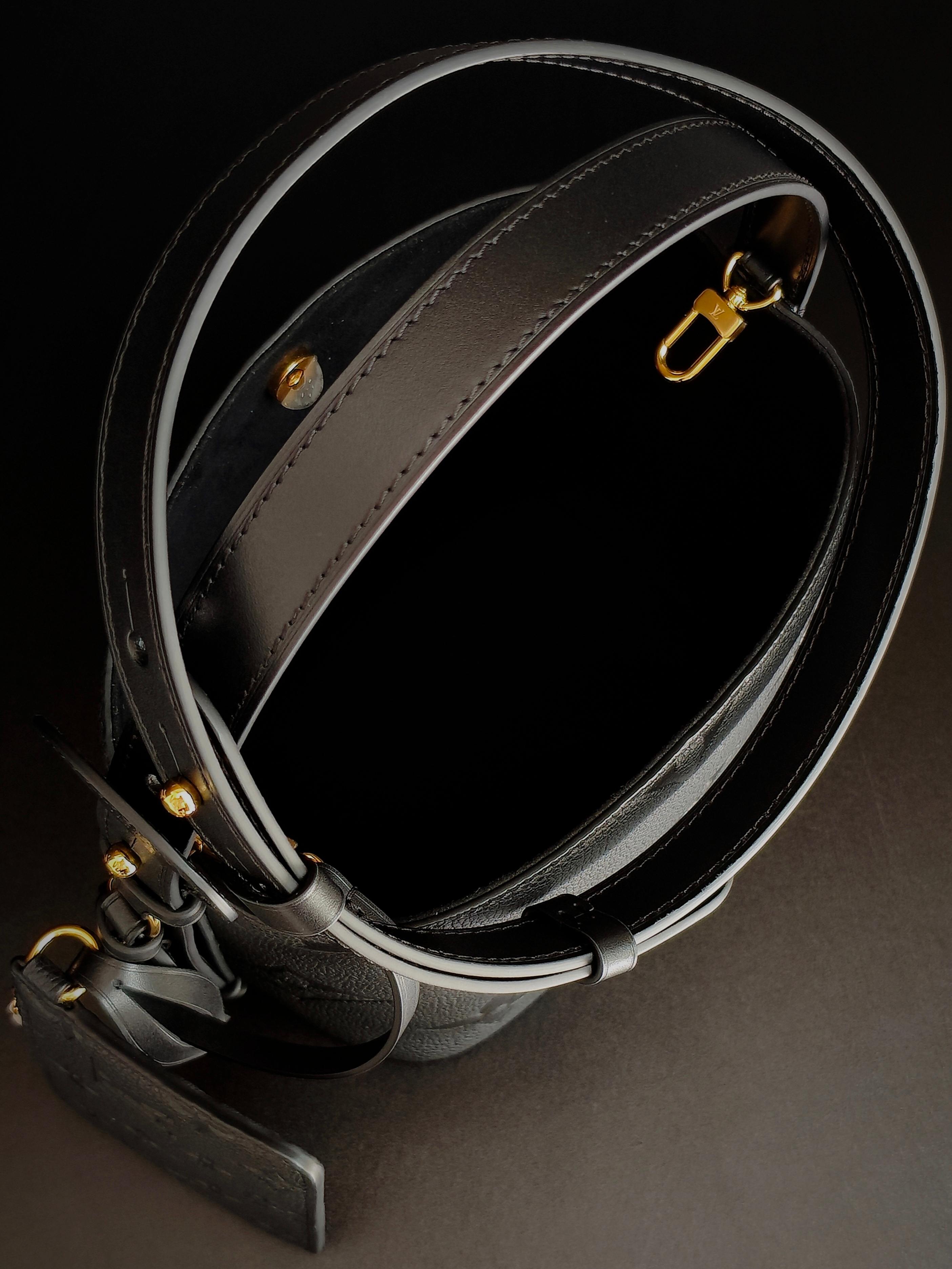 Louis Vuitton monogram bucket bag strap with gold buckle hardware in gray