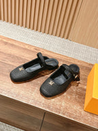 Louis Vuitton unisex black textured flats, front and side view, gold buckle detail