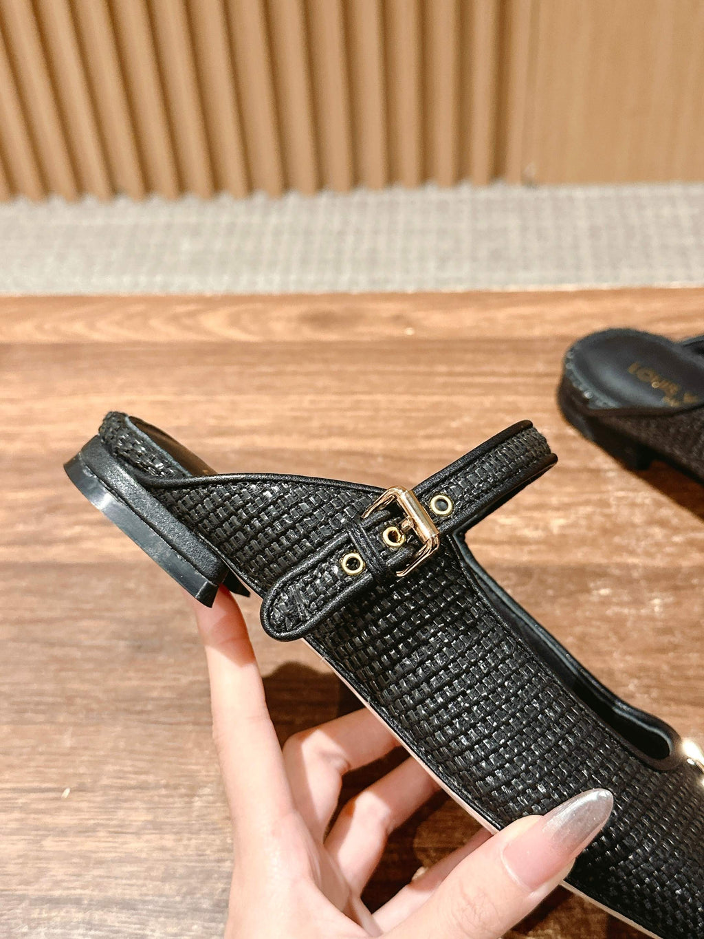 Louis Vuitton unisex black textured flats with T-strap and gold buckle, top view