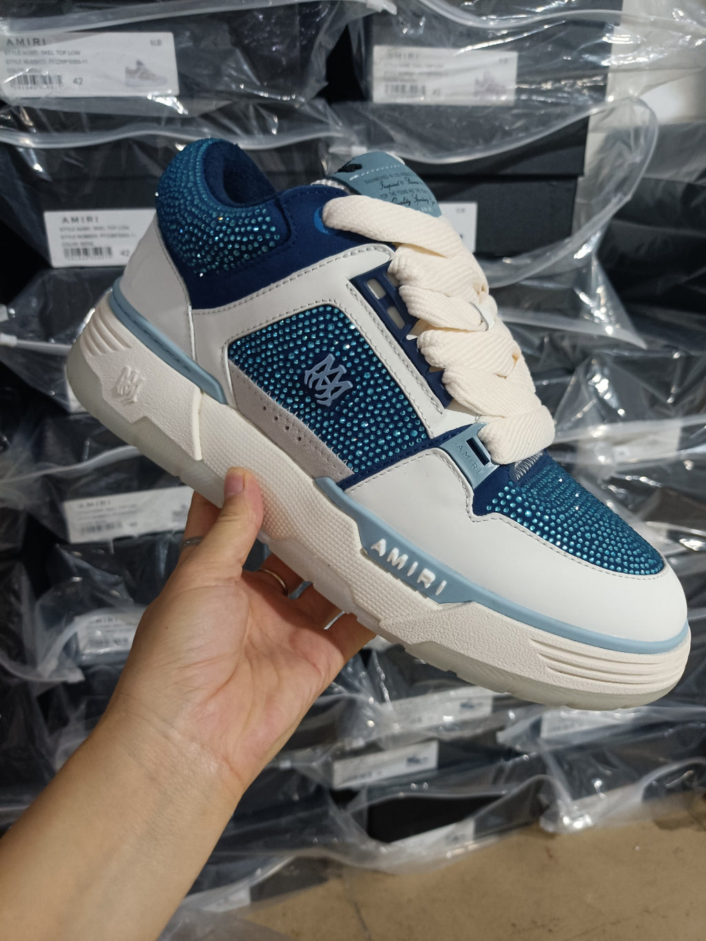 Blue and white low-top sneakers with rhinestone-style panels and lace-up closure