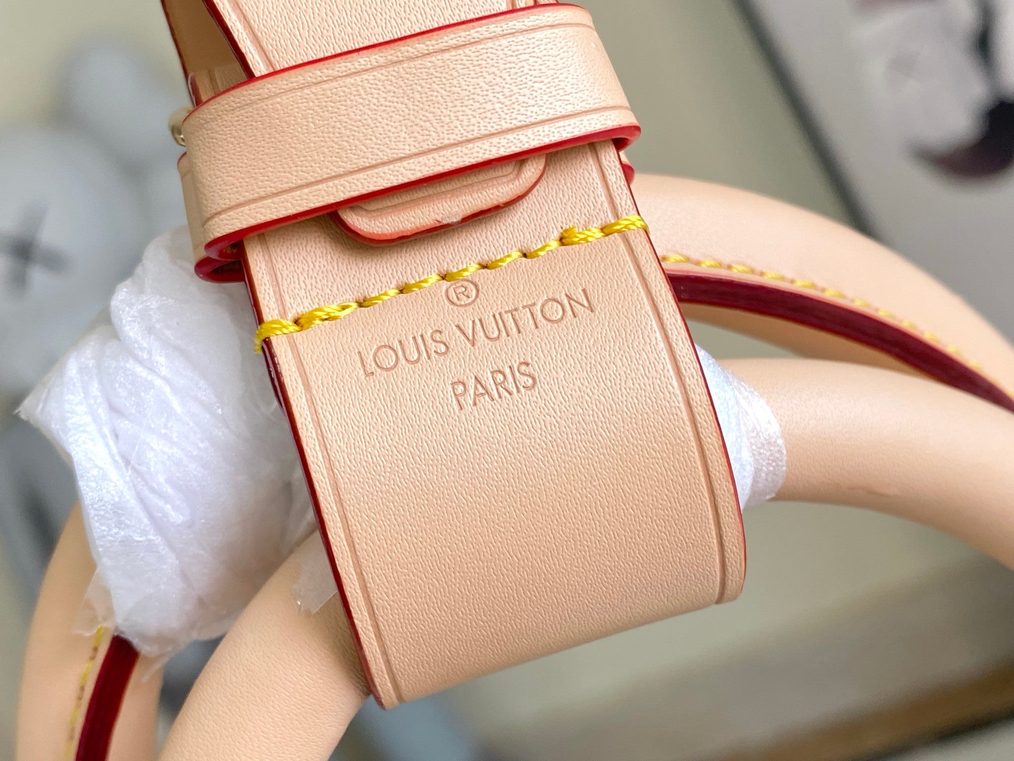 Louis Vuitton small leather pouch with strap, embossed Louis Vuitton Paris, and gold trim