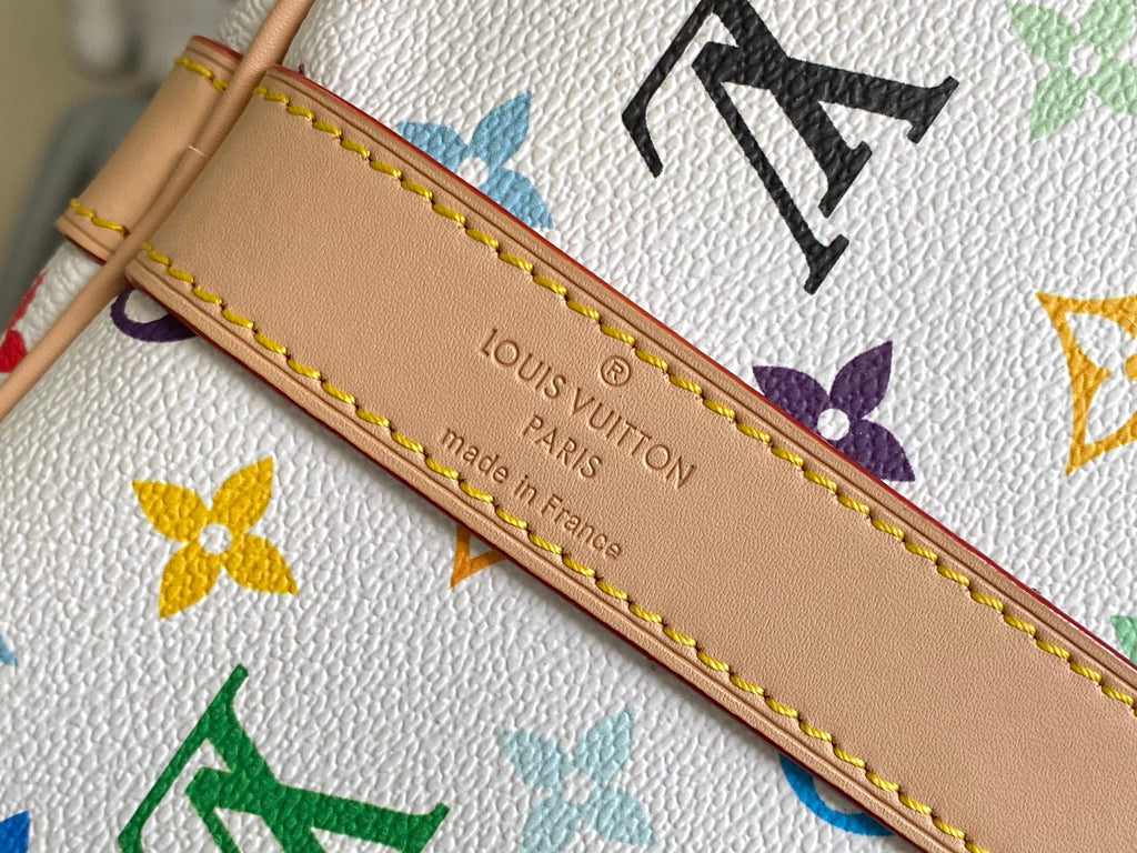 Men's Louis Vuitton monogram bag edge close-up with tan trim and gold stitching