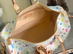 Men's Louis Vuitton duffel bag interior with tan lining and zipper pocket