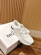 White Moncler low-top sneaker with lace-up closure and red/green collar stripe.
