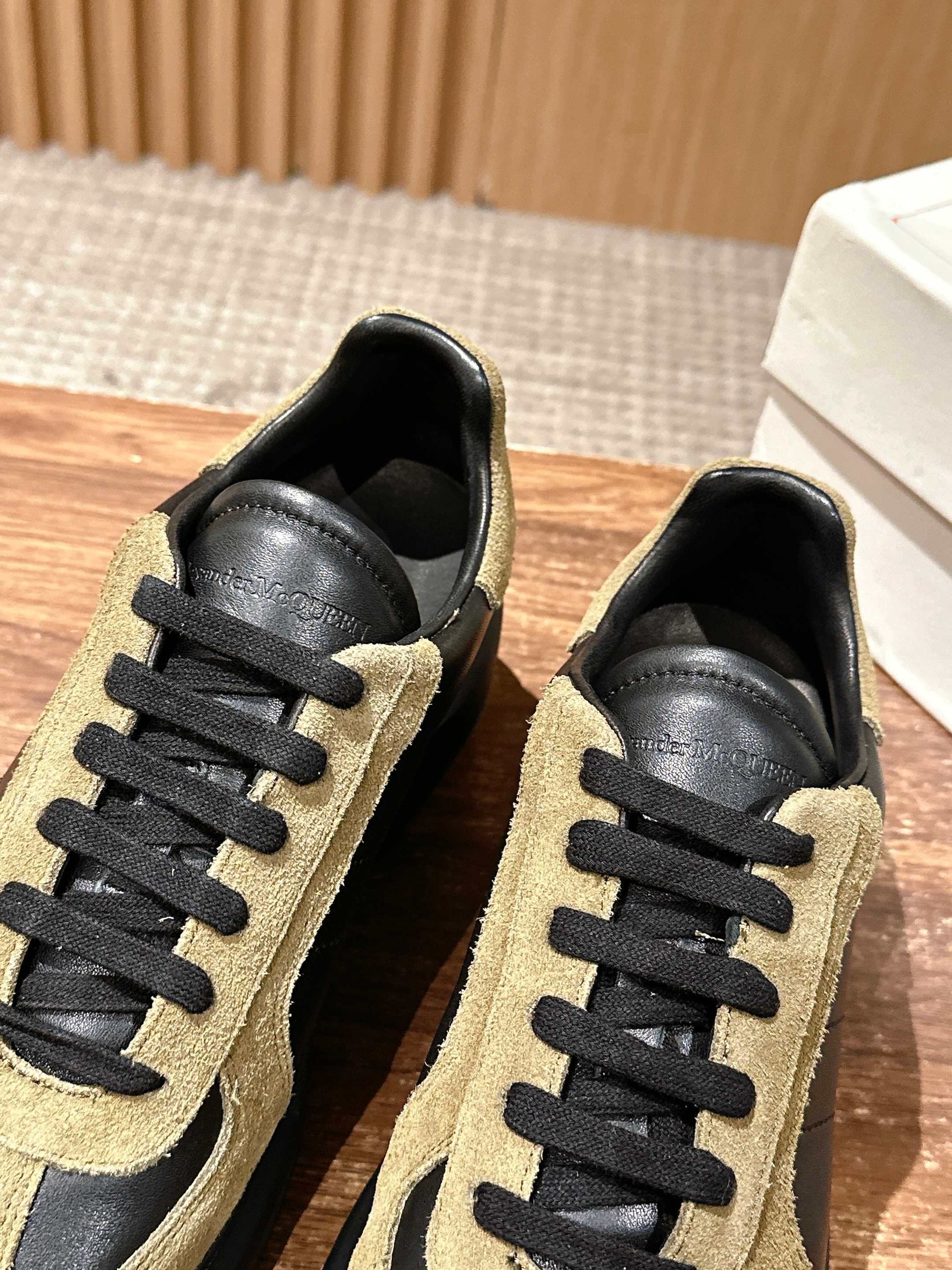 Alexander McQueen sneakers pair view, tan suede uppers with black laces and sole