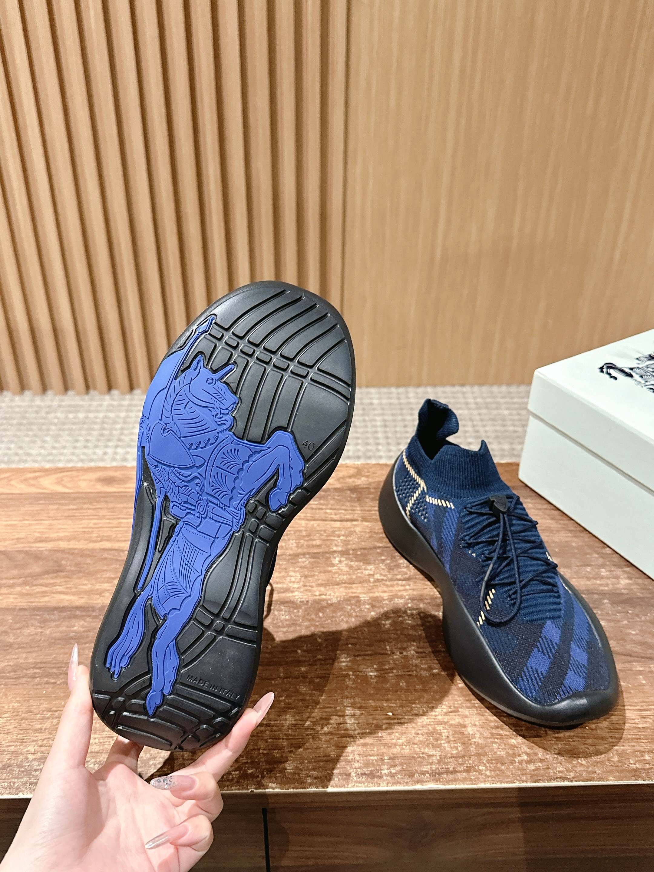 Burberry blue check sneaker outsole with deep tread and dark rubber heel edge