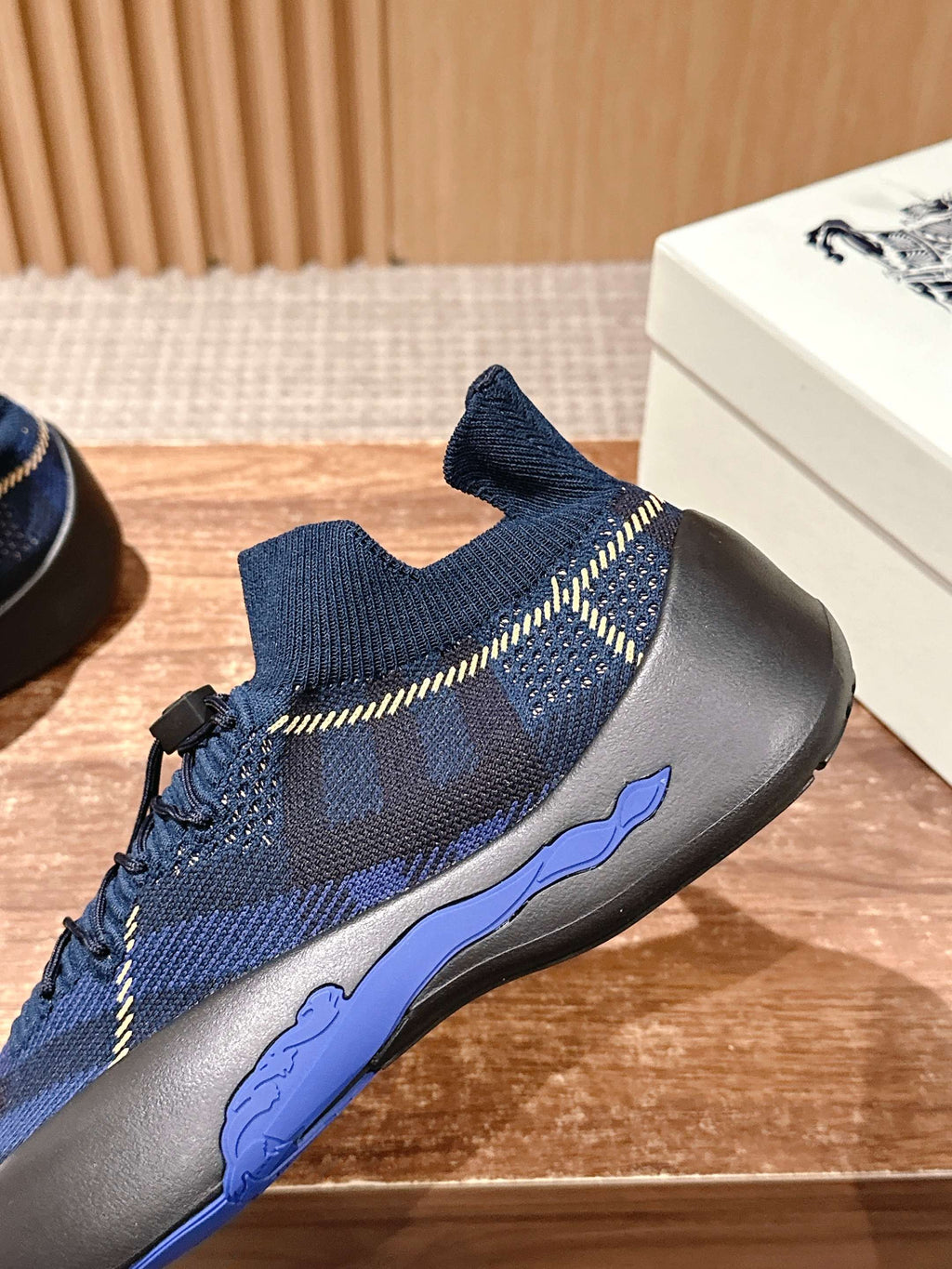 Burberry blue check knit sneaker with lace-up front, side seam stripes, and sole edge
