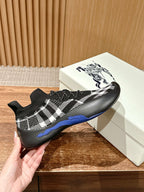 Black knit sock sneakers with white check pattern and blue side sole accent