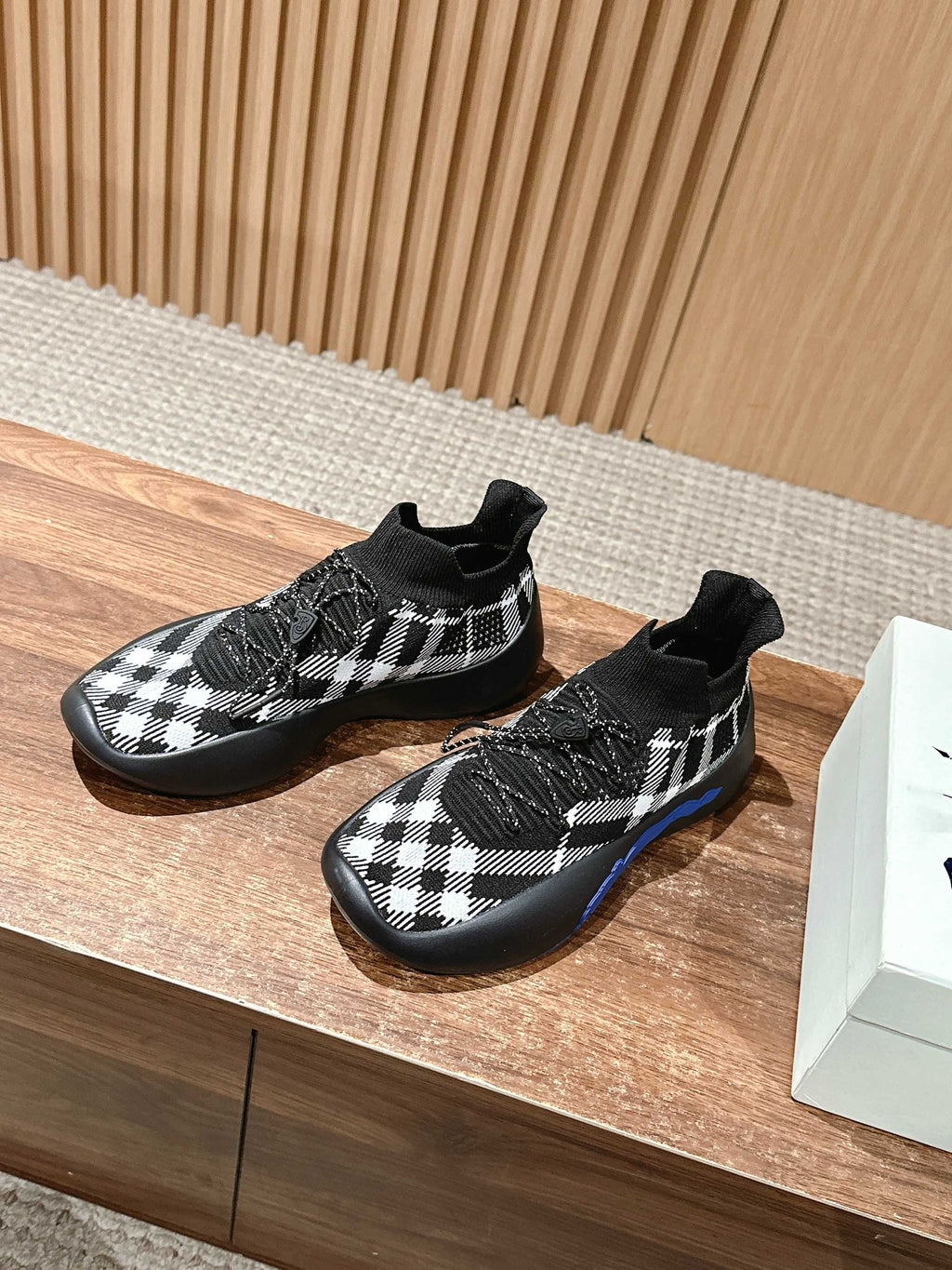 Knit sneakers in black and white check with sock-style collar and sole