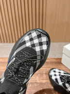 Close-up toe of black and white check knit sneaker with black laces