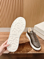 Sneaker outsole and side view, dark taupe leather upper with white rubber tread sole