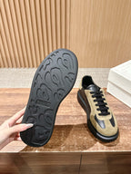 Alexander McQueen sneakers outsole view, black tread with tan-and-black upper