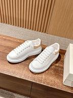 Alexander McQueen white low-top sneakers with gold glitter collar detail and lace-up front