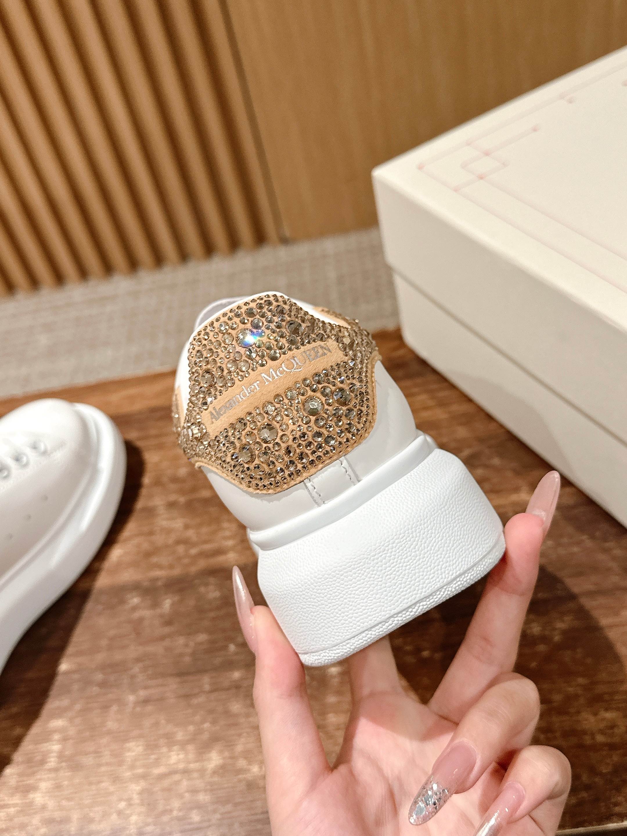 White leather sneaker with gold glitter toe and low-profile sole