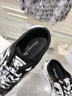 Close-up of Dior black lace-up sneaker side with white graphic panels