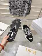 Outsole view of Dior black and white lace-up sneakers, showing tread pattern