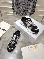 Dior black lace-up sneakers with white highlights on a white shoe box