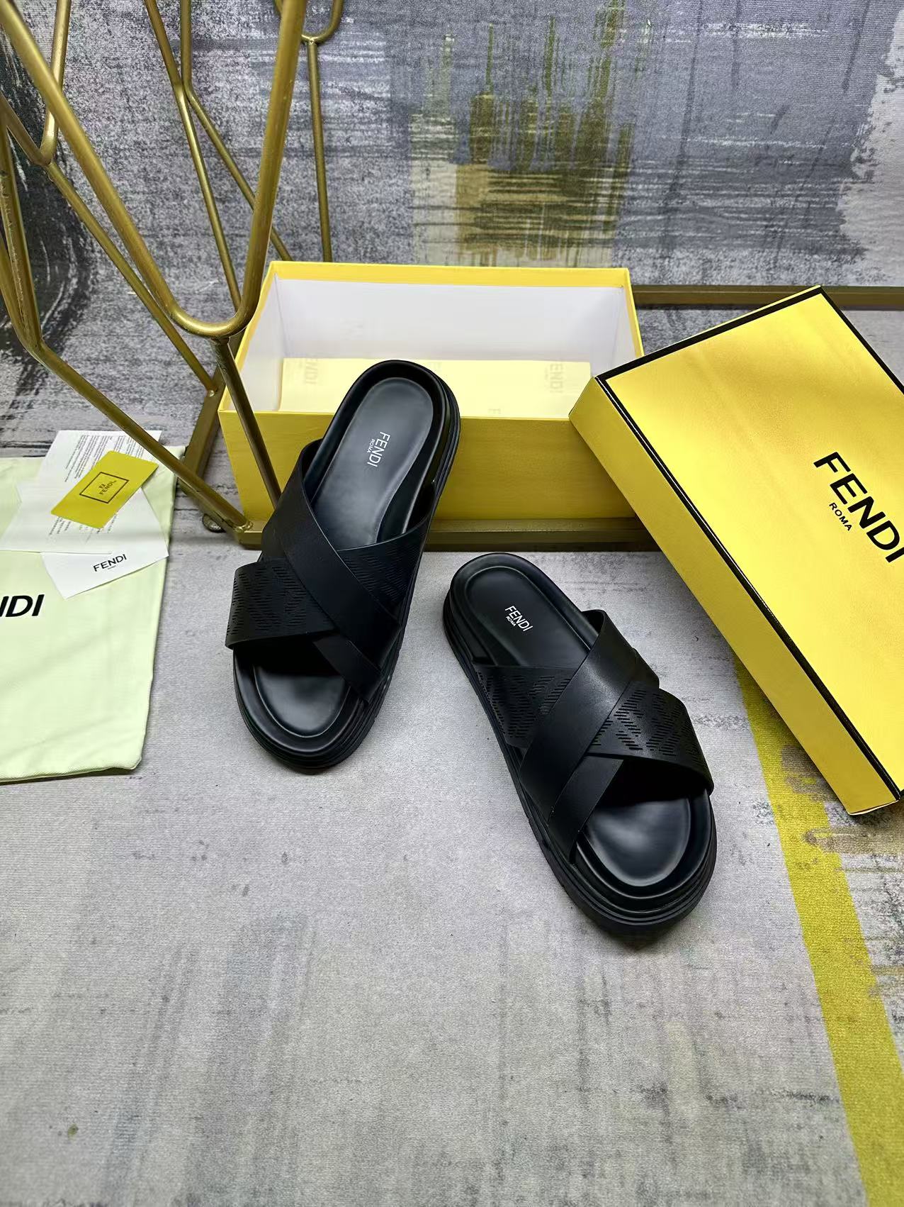 Black slide sandals with crossing straps and thick cushioned platform sole