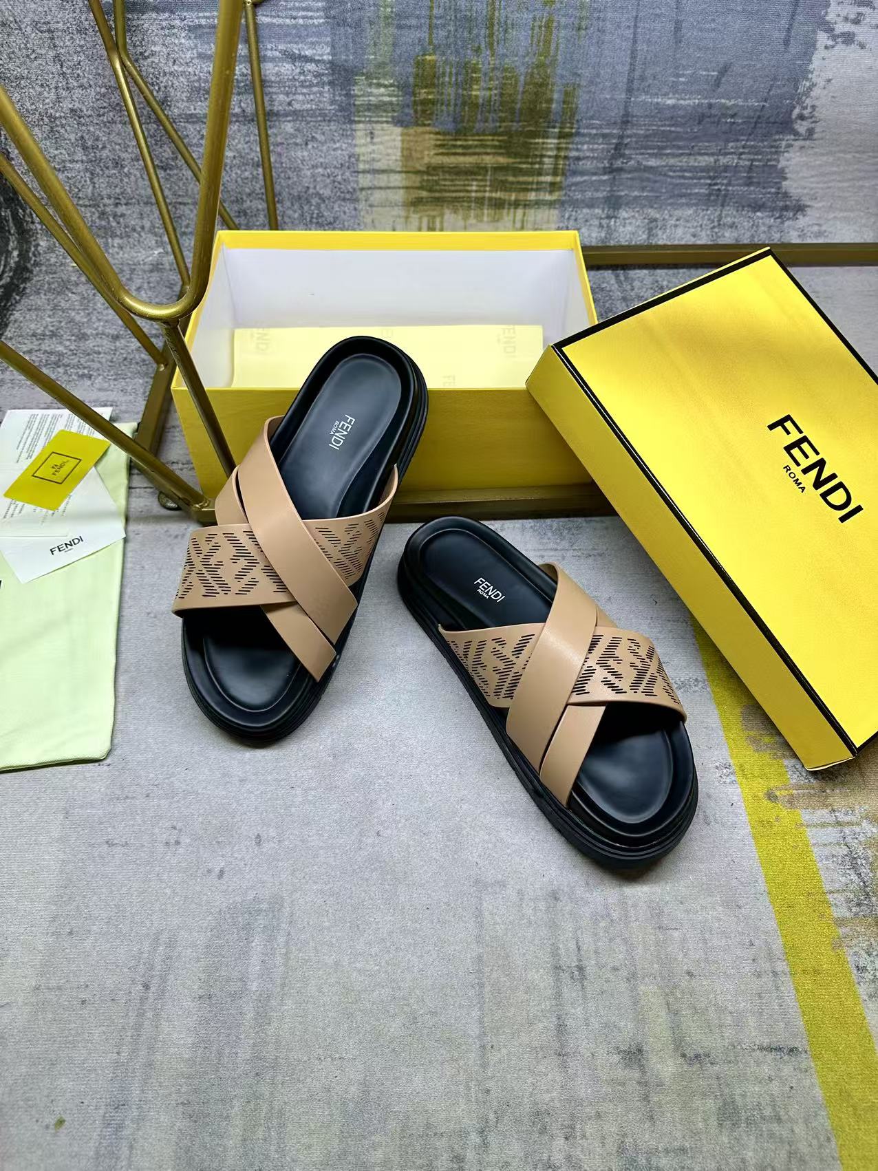 Pair of Fendi slide sandals with beige FF straps over black sole