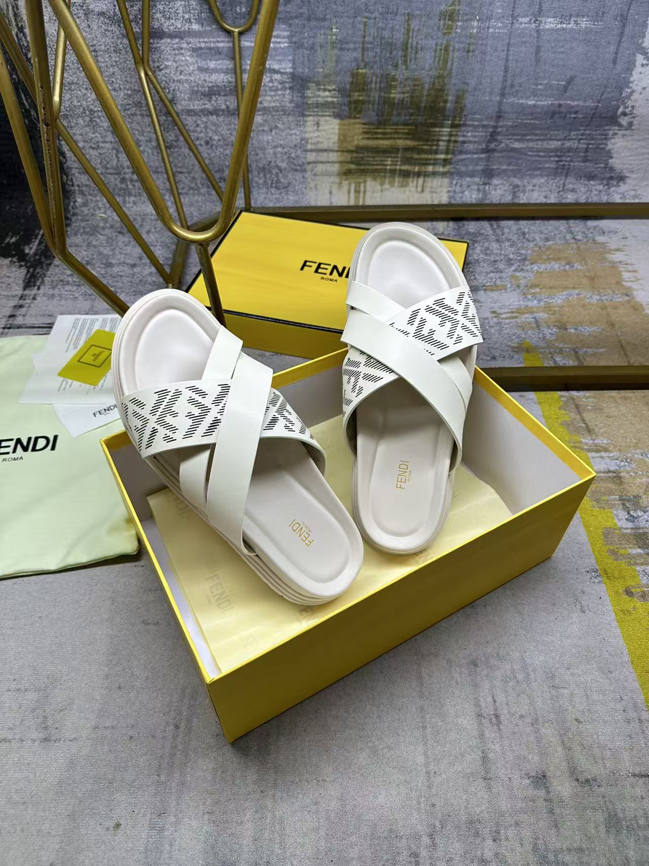 Fendi white slide sandals, angled view, double strap with FF logo pattern