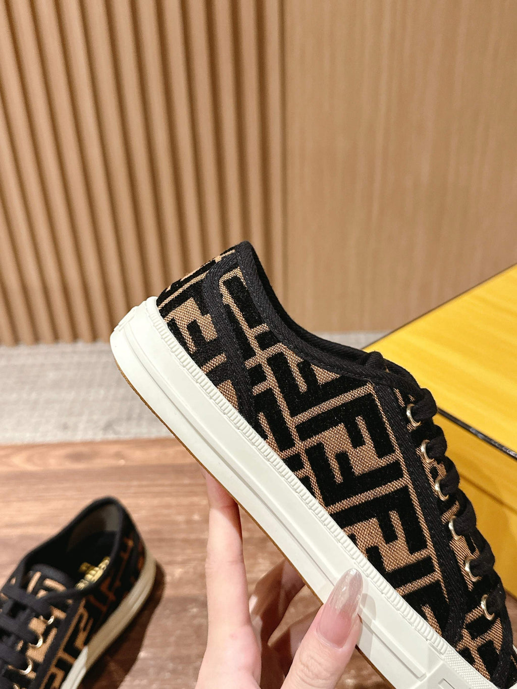 Fendi unisex sneaker side view, black FF logo canvas with white sole and lace trim