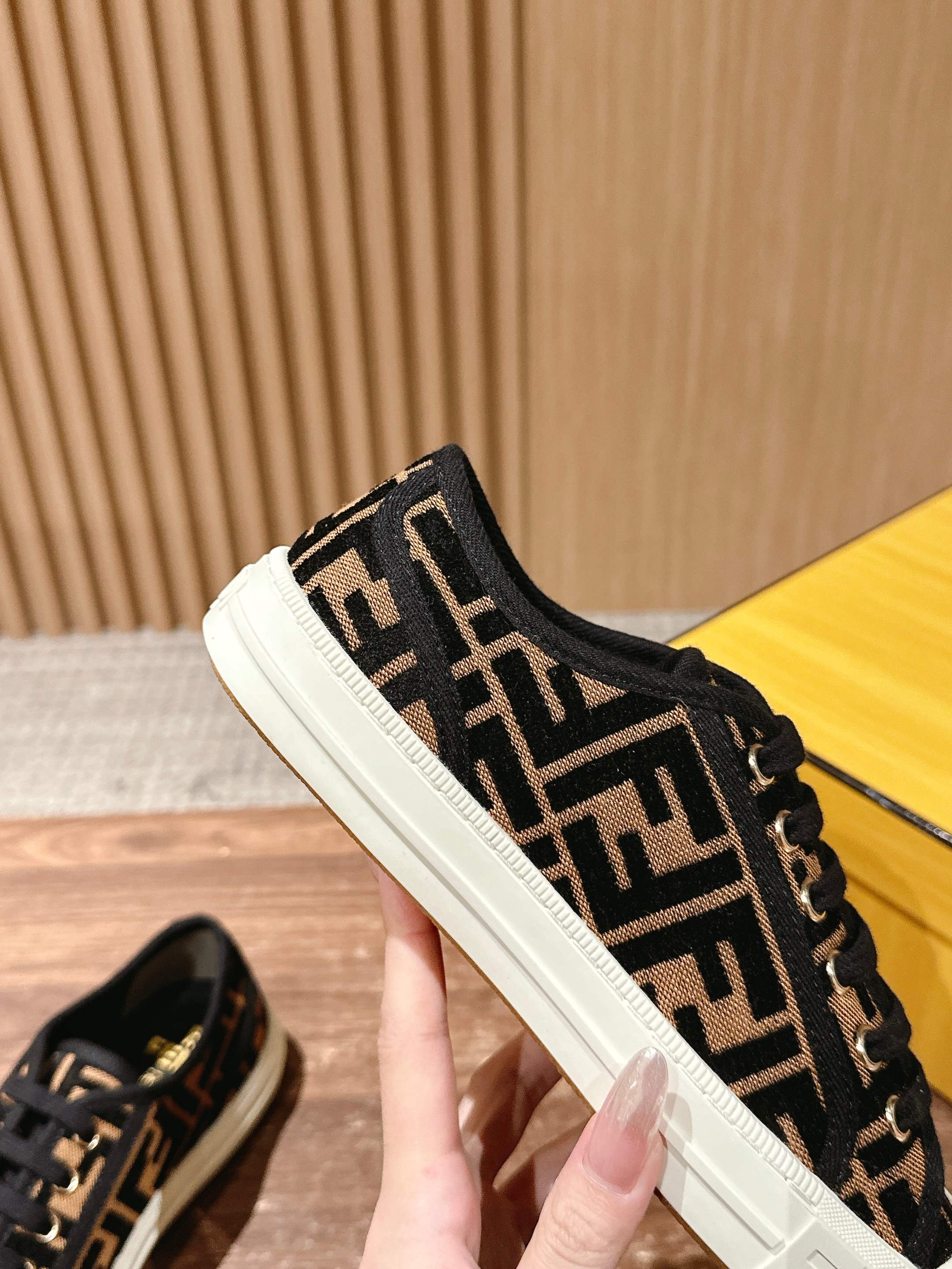 Fendi unisex sneaker side view, black FF logo canvas with white sole and lace trim