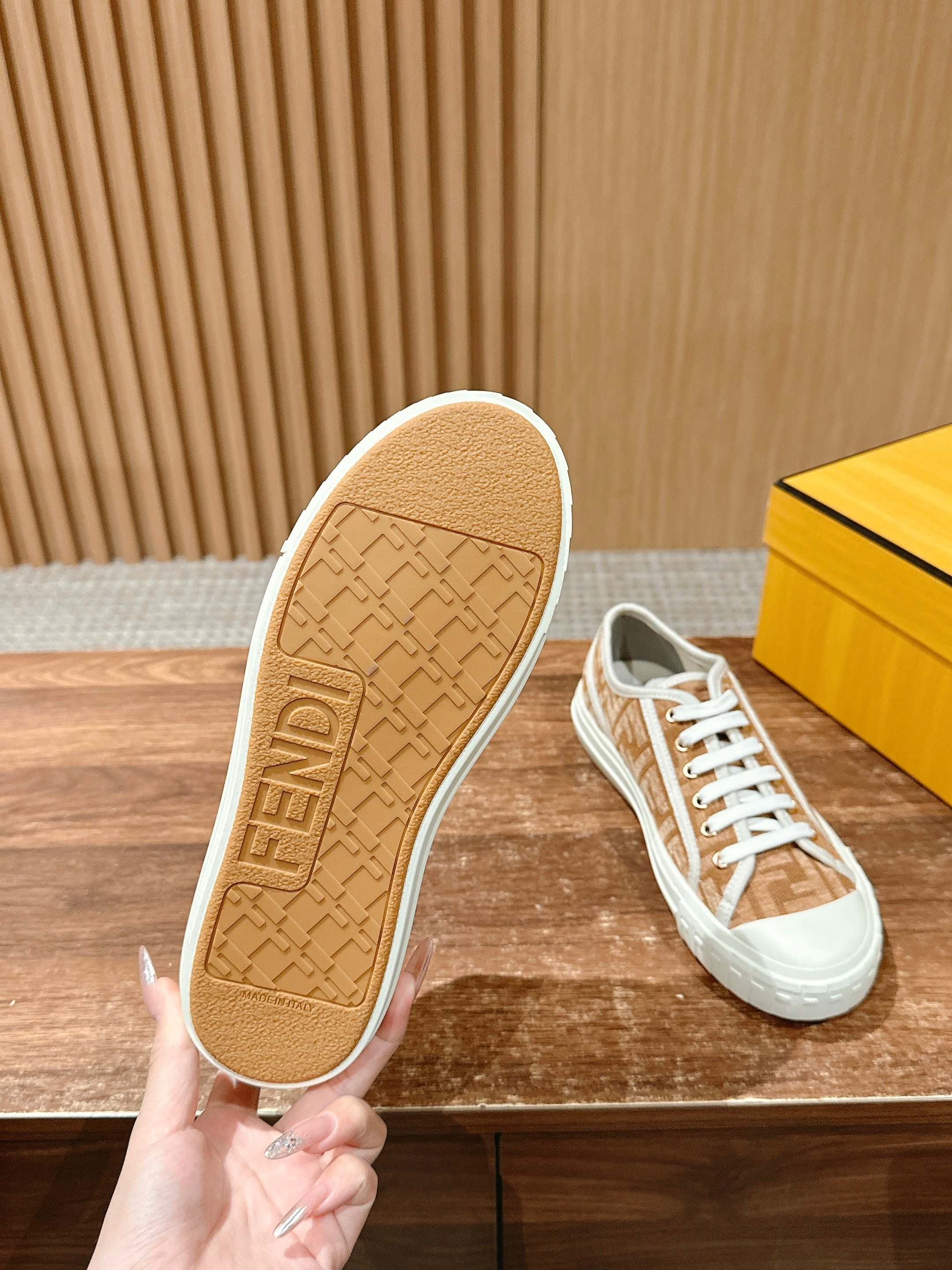 Fendi unisex sneaker outsole view, textured beige sole with FENDI lettering
