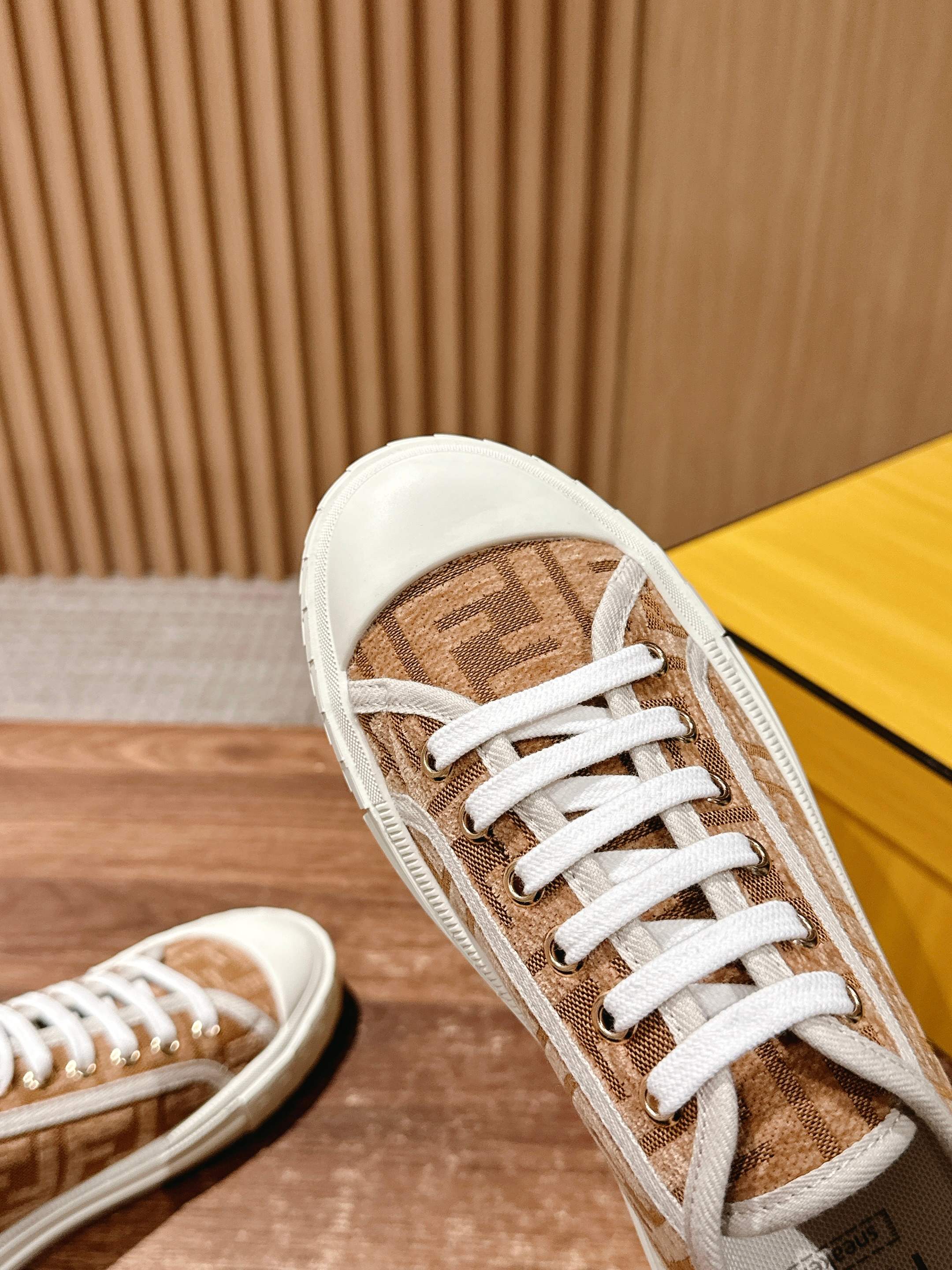 Fendi unisex sneaker front view, brown monogram upper with white laces