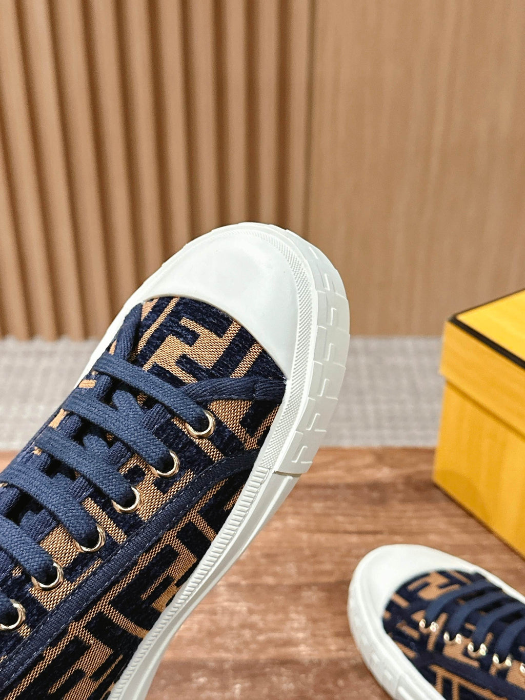 Navy and beige FF monogram sneaker with white sidewall and blue lace-up panel