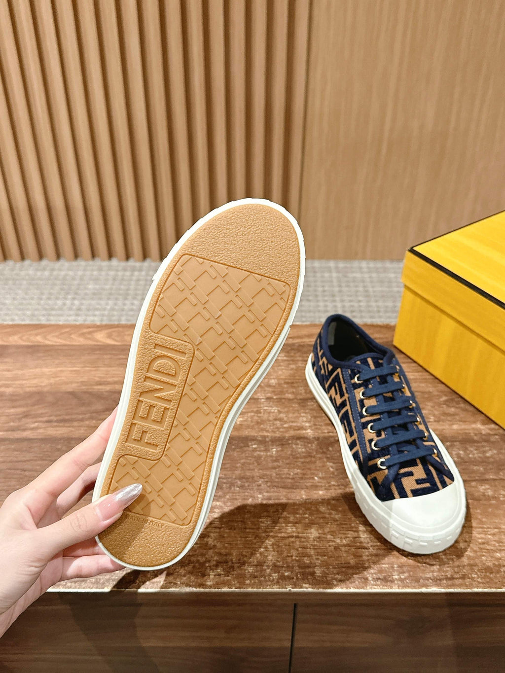 Navy FF monogram sneaker with white sole; outsole shown in beige with embossed tread
