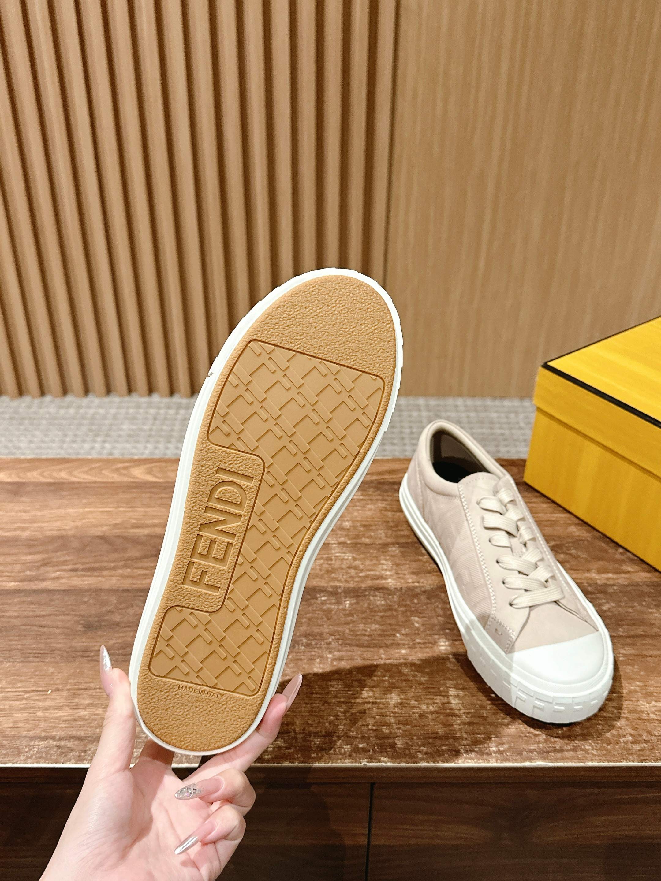 Beige sneaker outsole with FENDI logo text pattern and white sidewall, unisex.