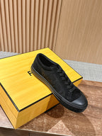 Fendi unisex black lace-up sneaker resting on yellow box