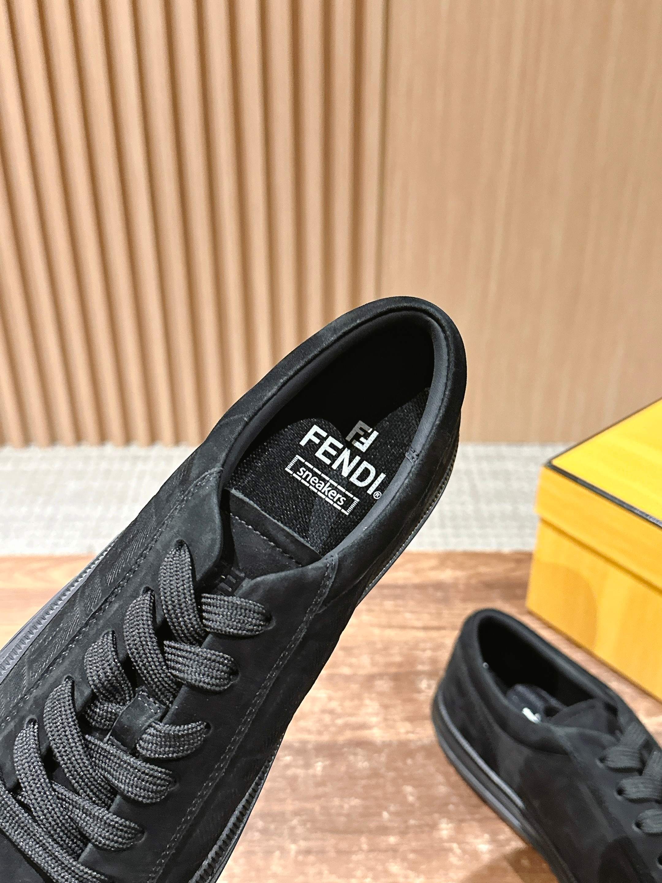 Fendi unisex black lace-up sneaker close-up with FENDI logo on tongue