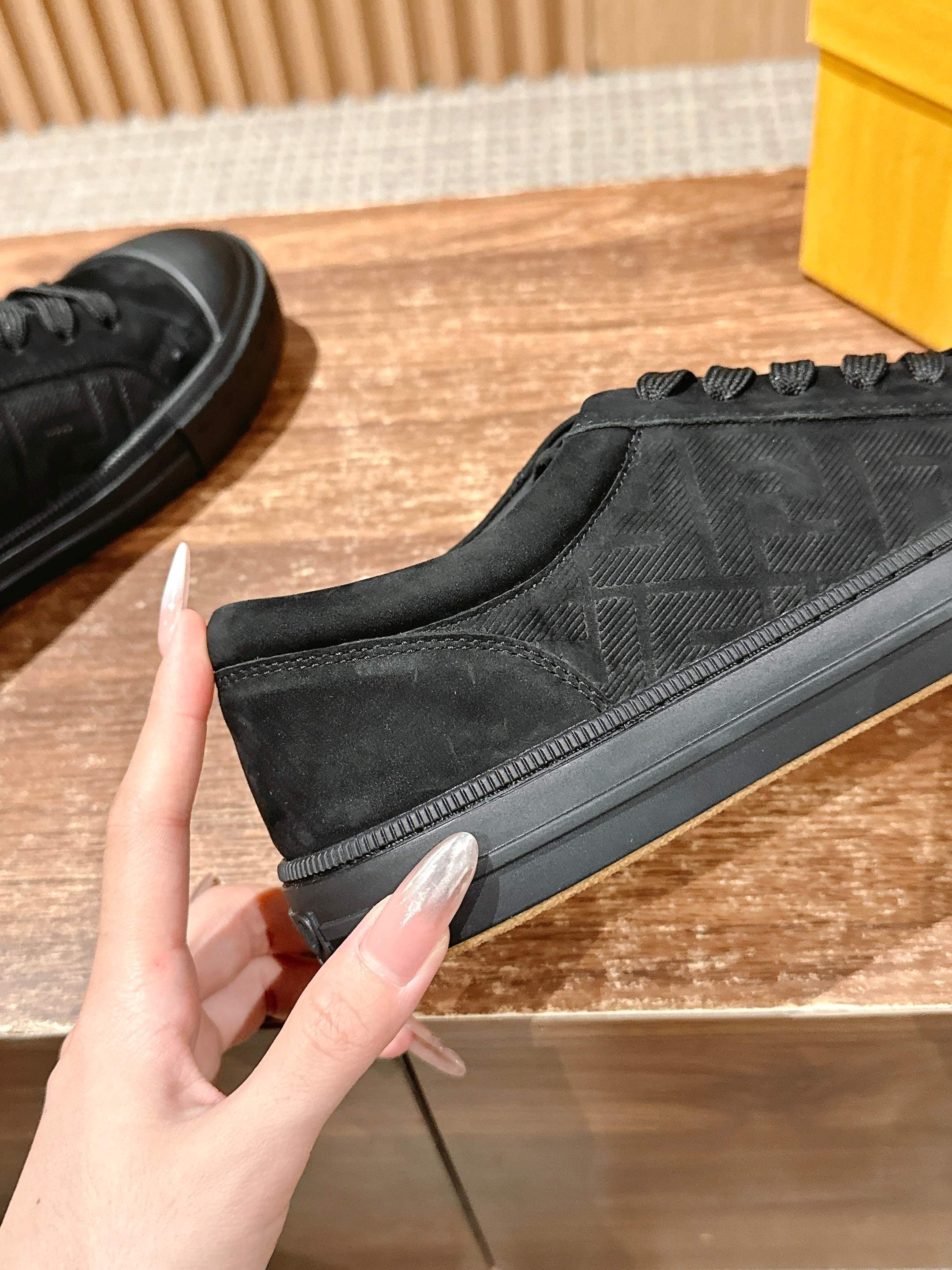 Fendi unisex black lace-up sneaker close-up, textured side panel
