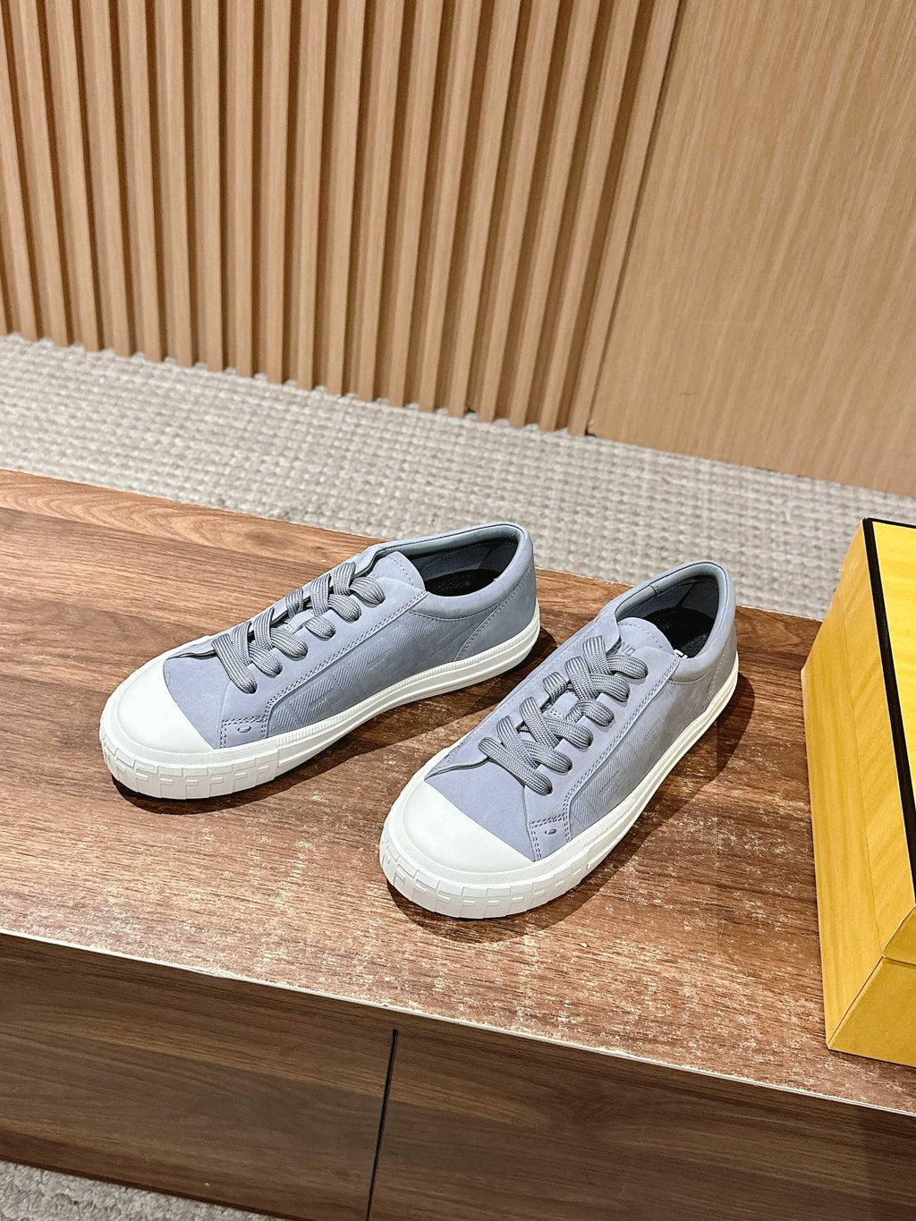Pair of gray lace-up low-top sneakers with textured white midsoles