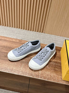 Pair of gray lace-up low-top sneakers with textured white midsoles