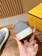 Gray sneaker profile with white sidewall and embossed FENDI logo on strap