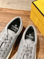 Gray FENDI sneakers close-up of tongue and lining with printed brand logo
