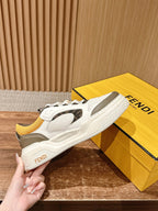 Fendi unisex sneakers close-up with FENDI heel text, white and gray with orange laces
