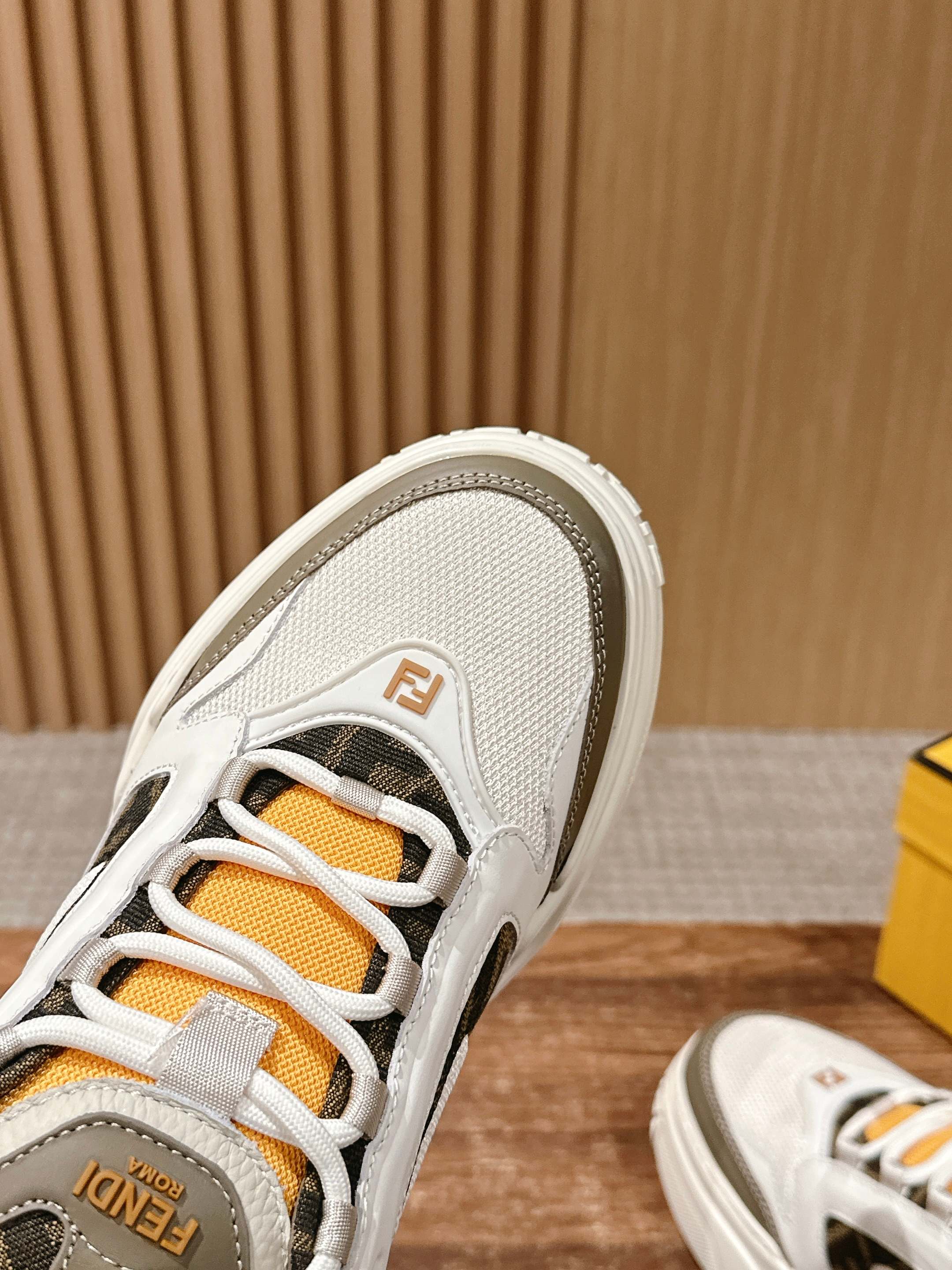 Fendi unisex sneaker toe and laces, white upper with orange lace panel