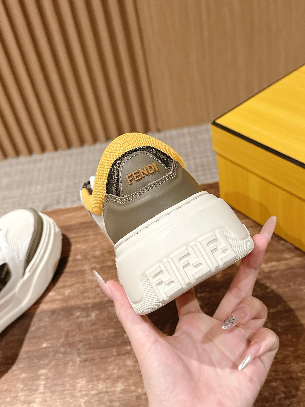 Fendi unisex sneaker heel and back, yellow collar with FENDI logo on white sole