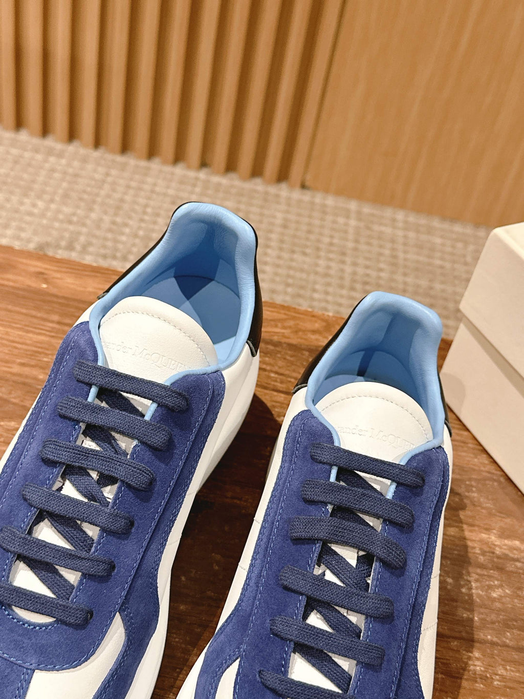 Pair of blue-and-white low-top sneakers with navy laces and light-blue interior lining