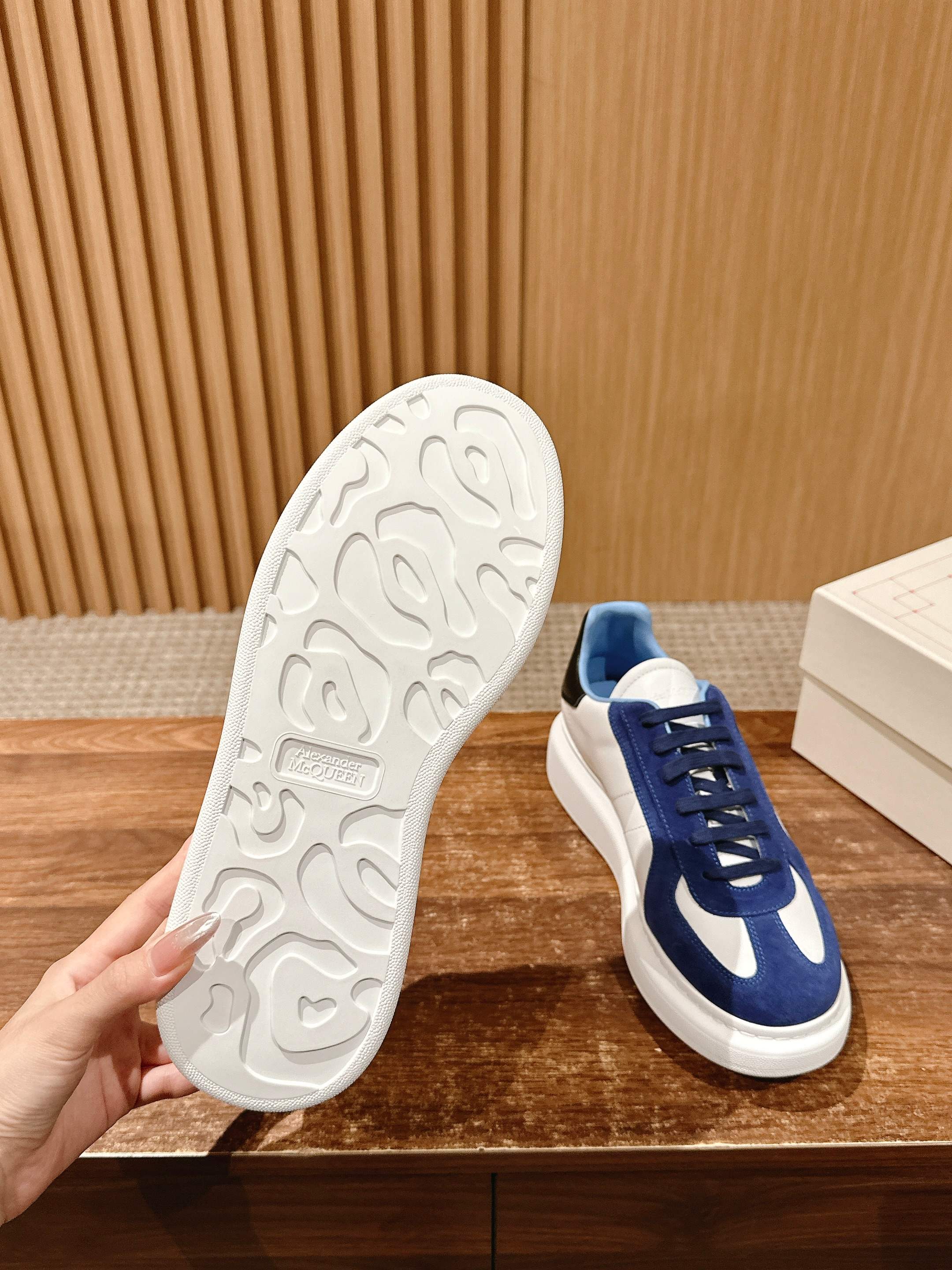 Blue-and-white low-top sneakers with white rubber outsole and textured tread