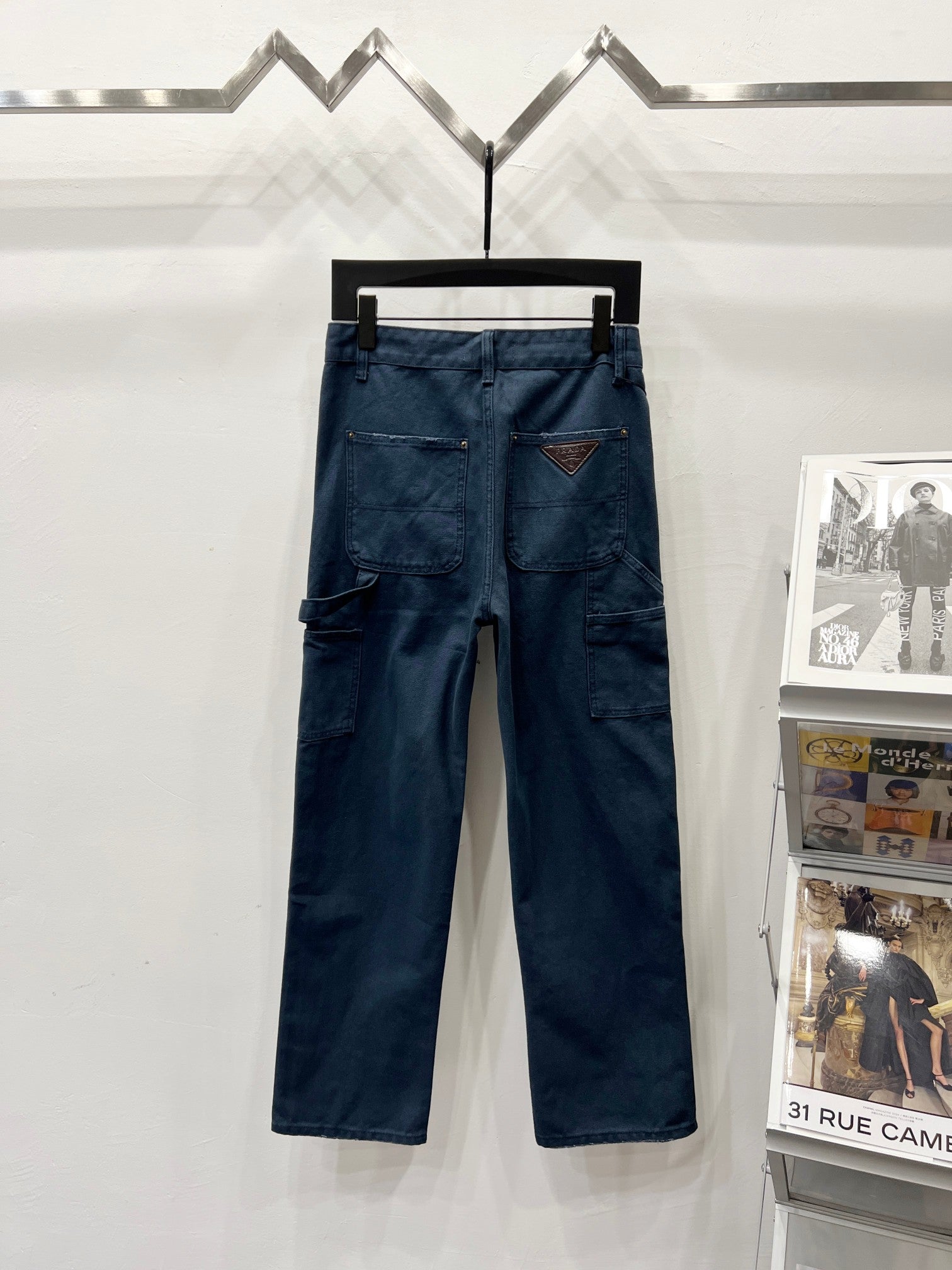 Dark blue denim cargo pants with front patch pockets and stitched seams