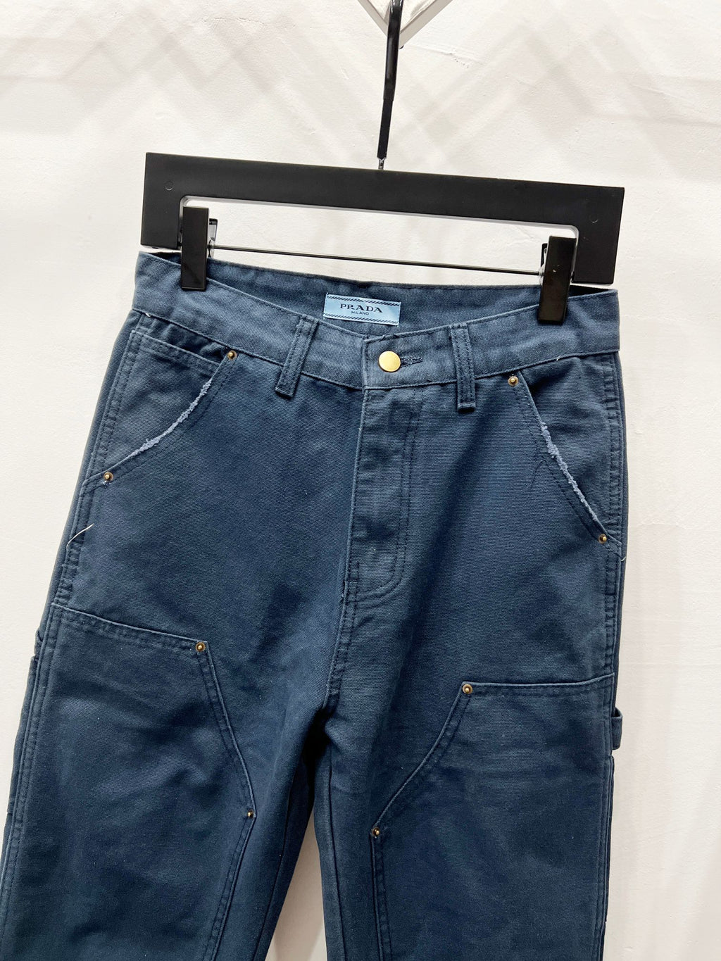 Dark blue denim pants with side cargo pockets and belt loops